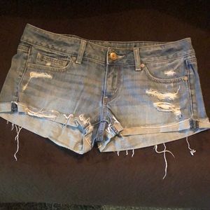 Medium-wash distressed denim shorts